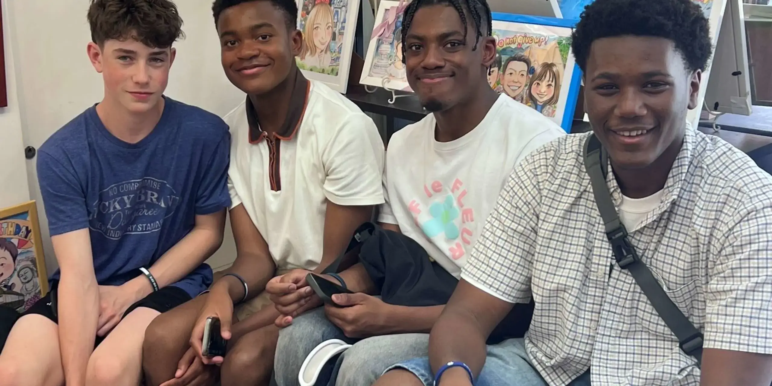 Four boys smiling for a photo